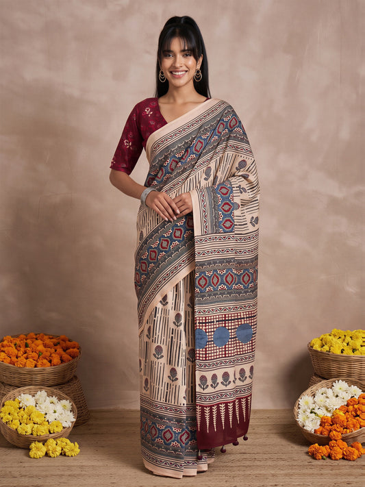 Woman wearing cream viscose silk saree with ajrak block-print motif work and maroon blouse