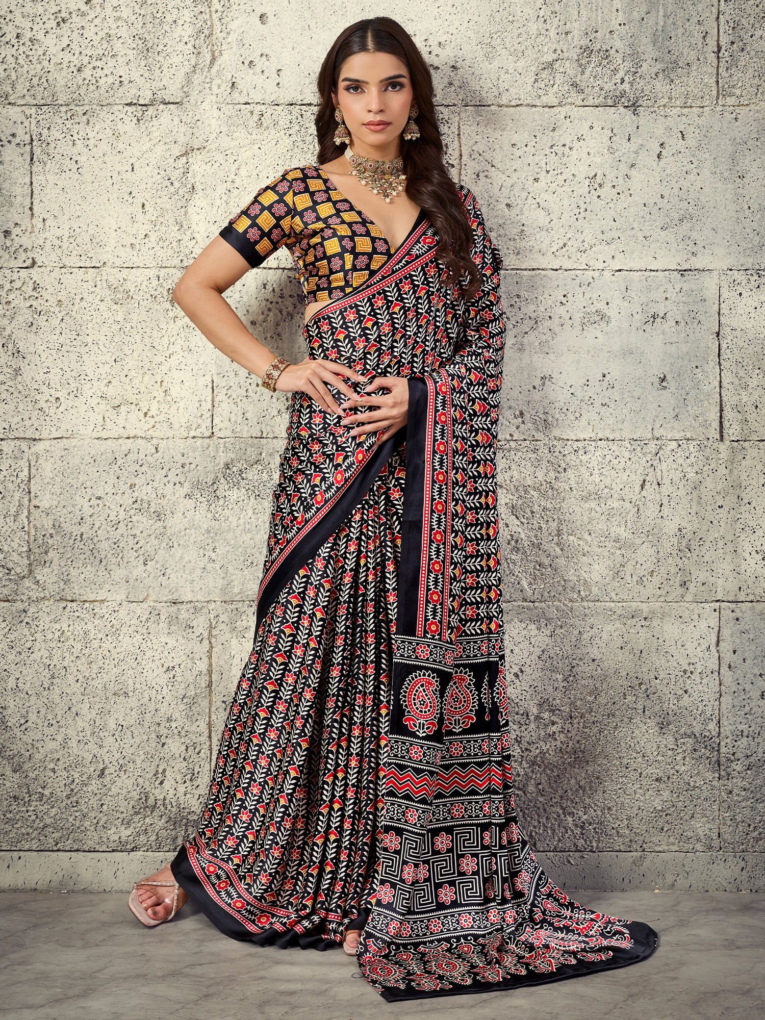 Woman wearing black satin saree with ajrak block-print motif work and black blouse