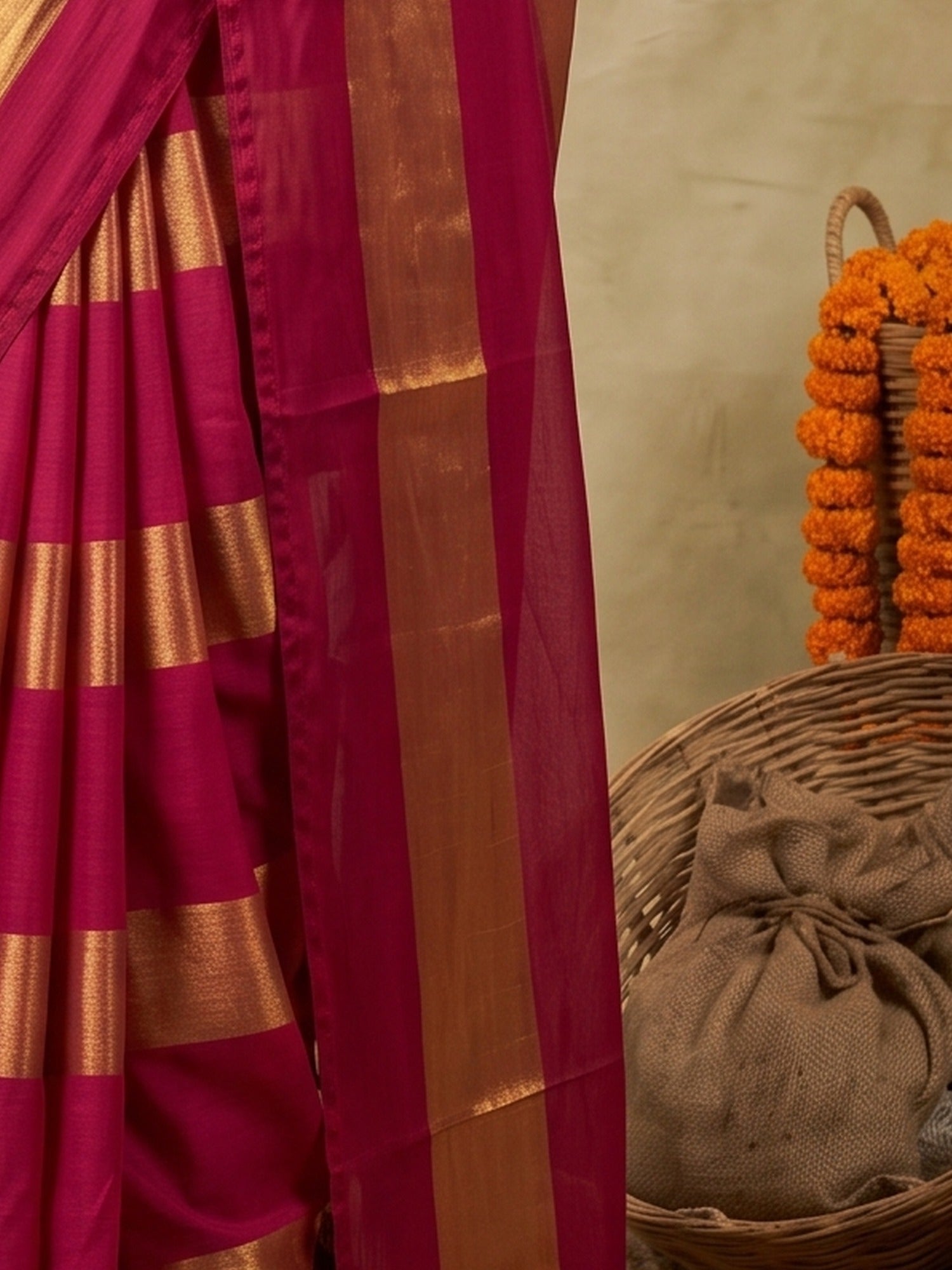 Pallu detail of red satin saree showing metallic foil print work and solid border