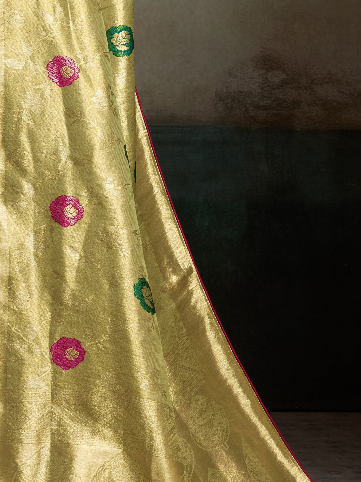 Pallu detail of yellow banarasi silk saree showing zari butta (metallic motif) work and zari border