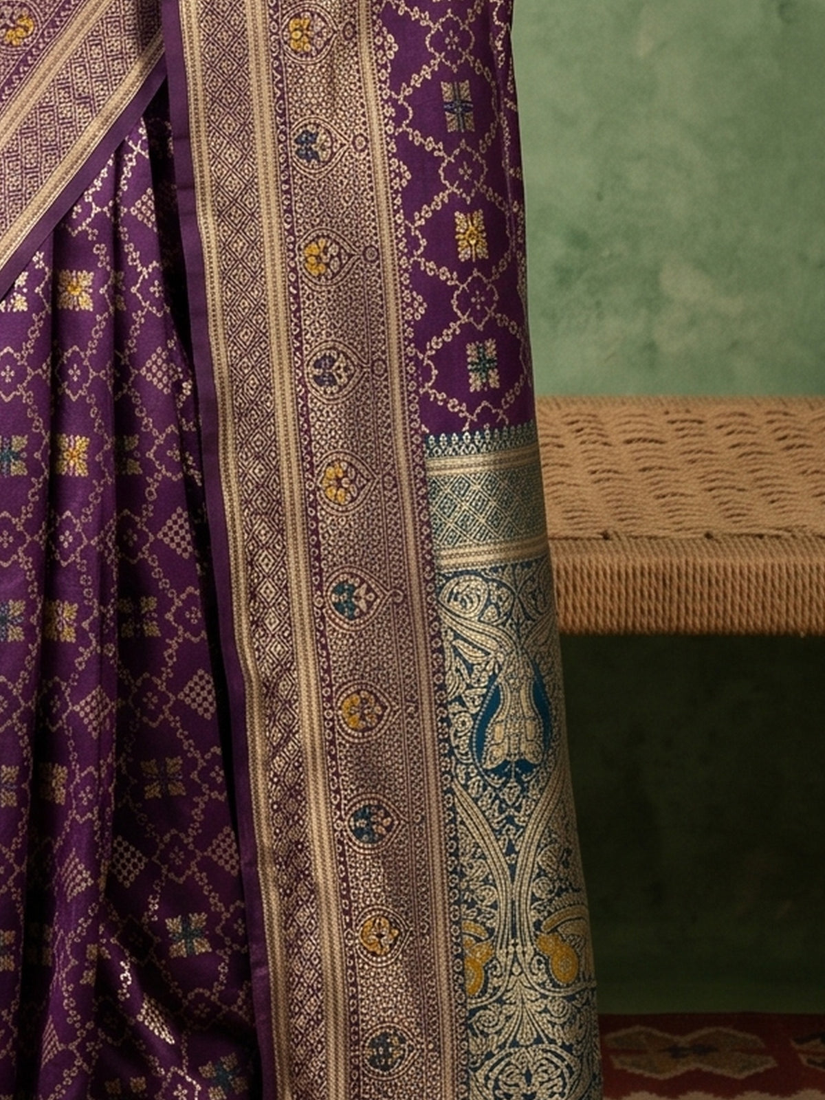 Pallu detail of purple silk blend saree showing traditional indian motif work and zari border