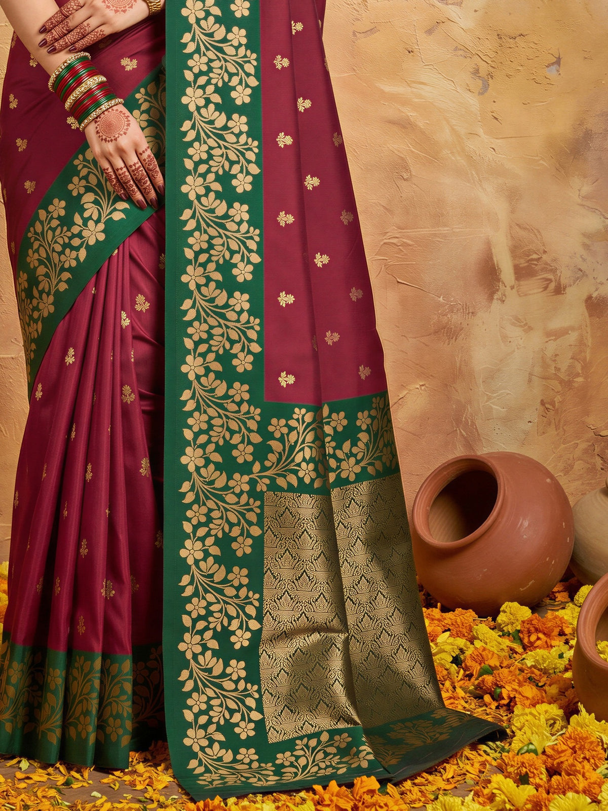 Pallu detail of maroon cotton blend saree showing all-over floral design and zari border
