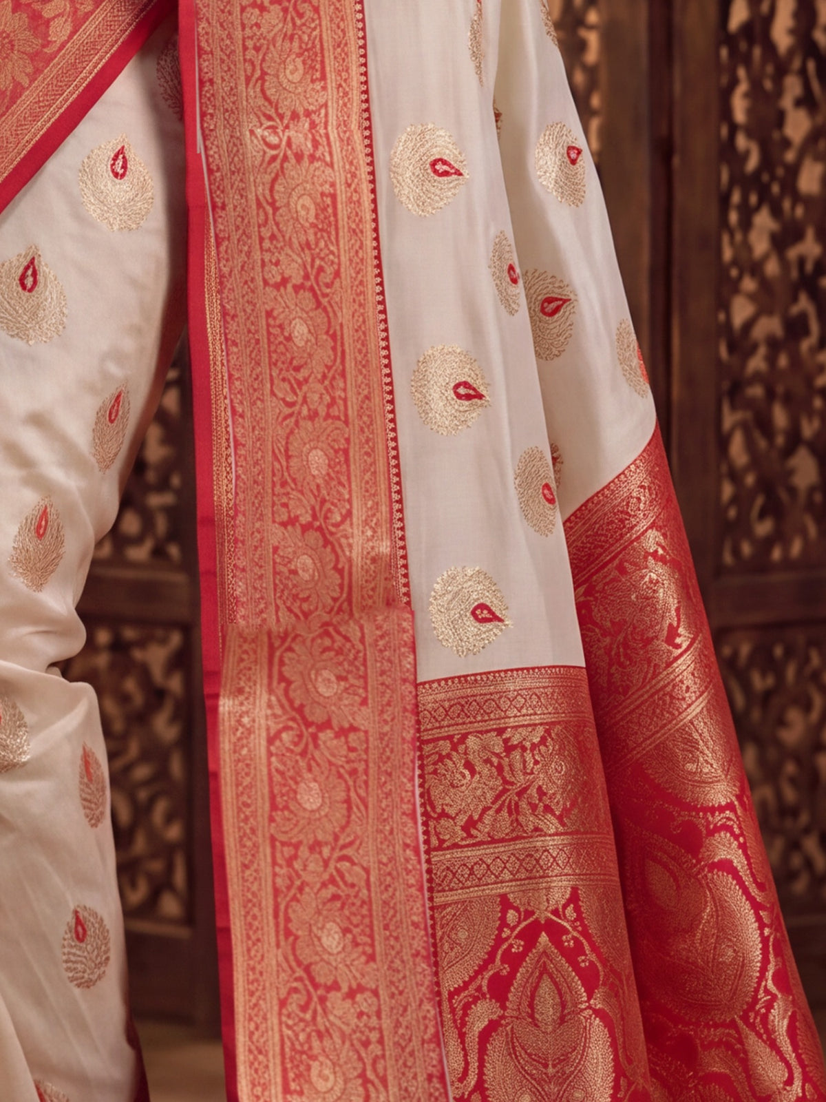 Pallu detail of white banarasi silk saree showing zari butta (metallic motif) work and zari border