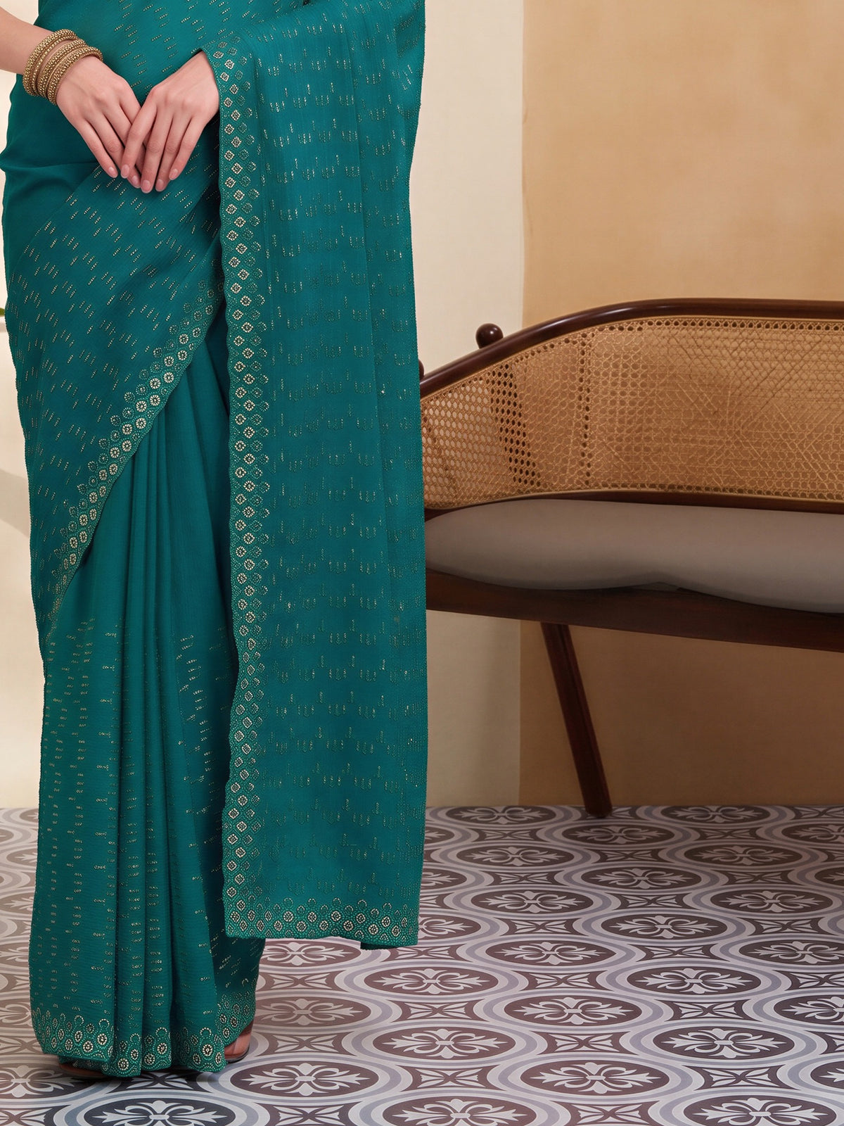 Pallu detail of teal green tissue saree showing geometric pattern design and embellished border