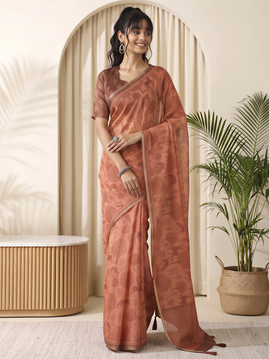 Woman wearing rust cotton linen saree with traditional indian motif work and light brown blouse
