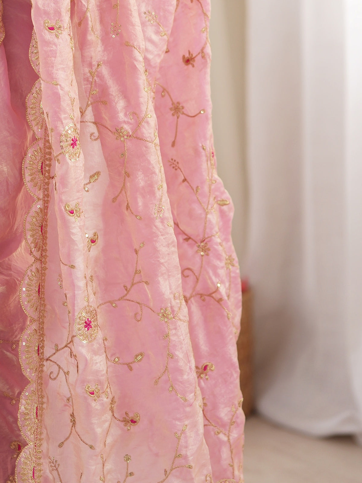 Pallu detail of pink organza saree showing ornamented surface design and embellished border