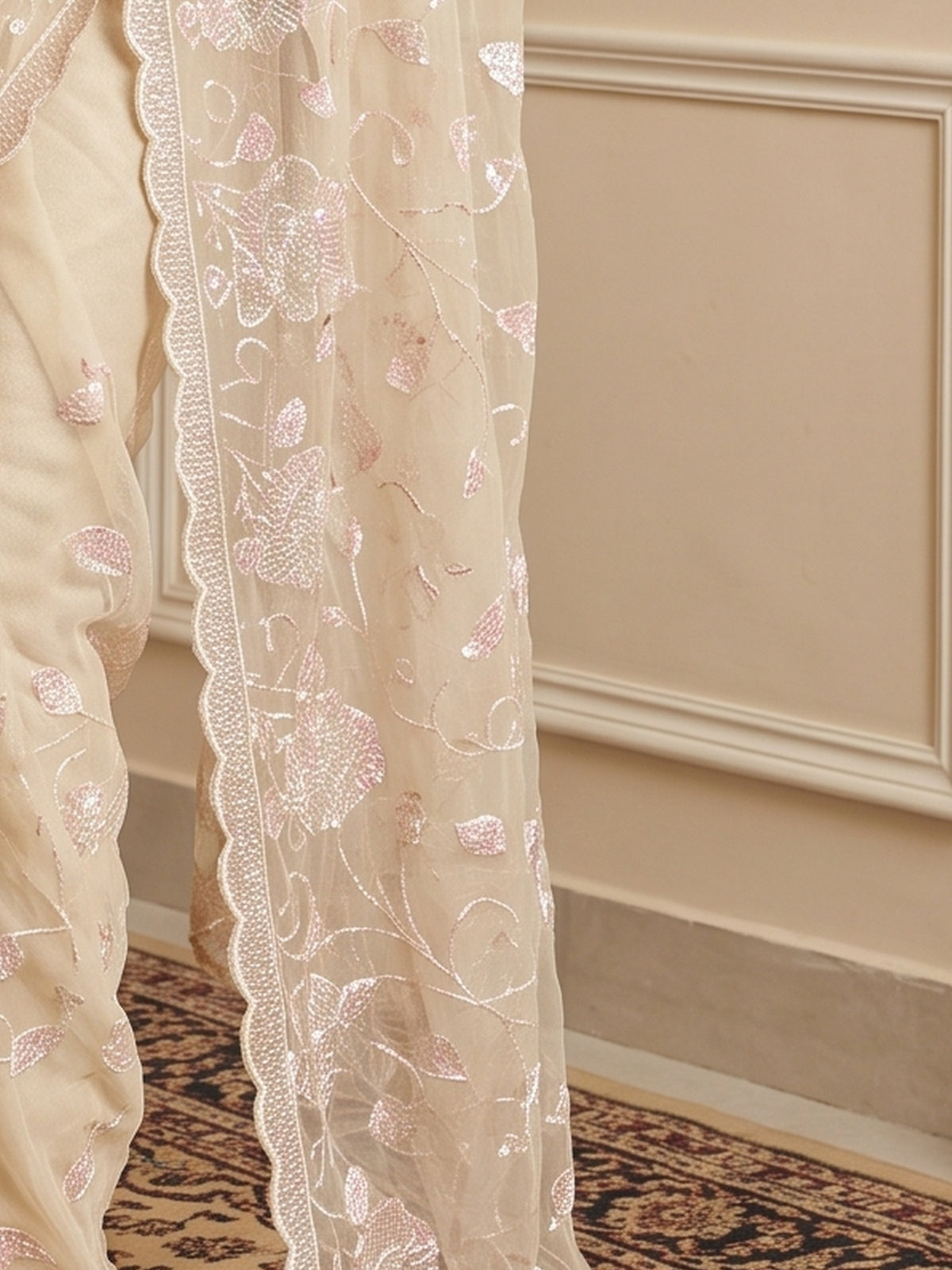 Pallu detail of off white georgette saree showing ornamented surface design and embellished border