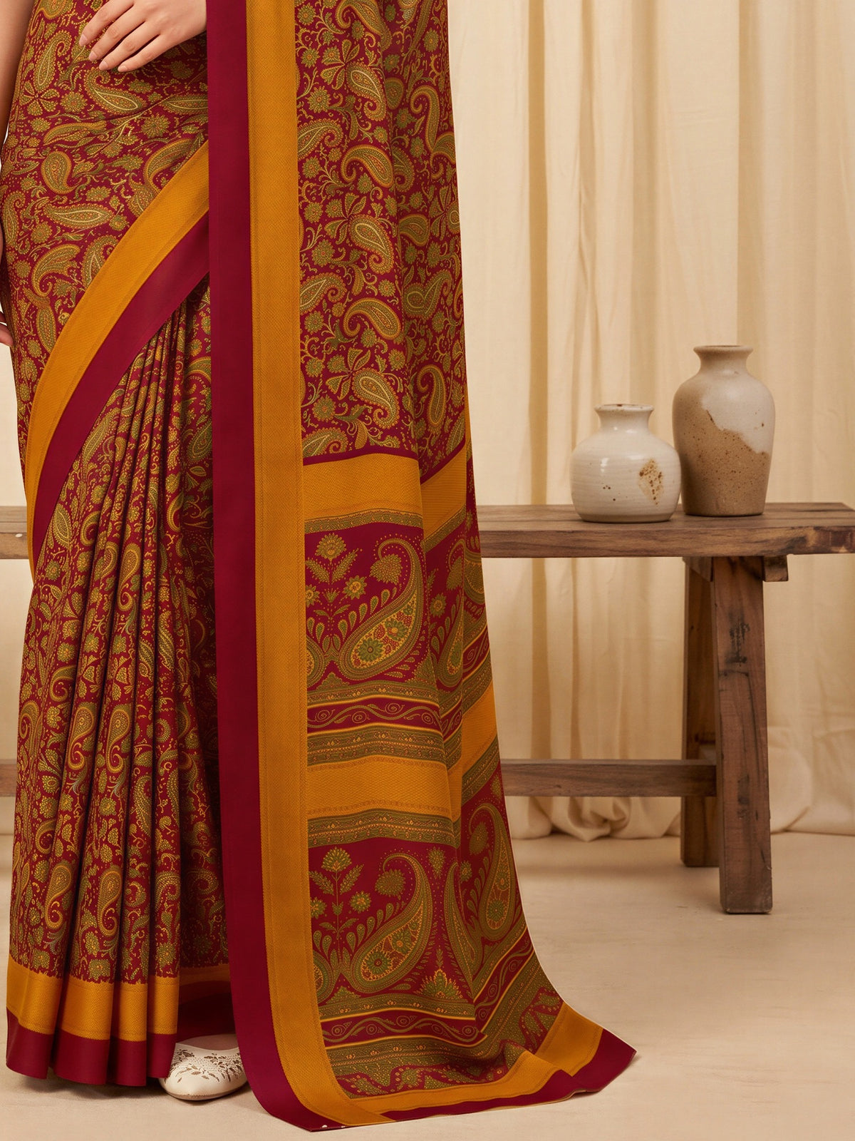 Pallu detail of maroon crepe saree showing bagh block-print motif work and printed border