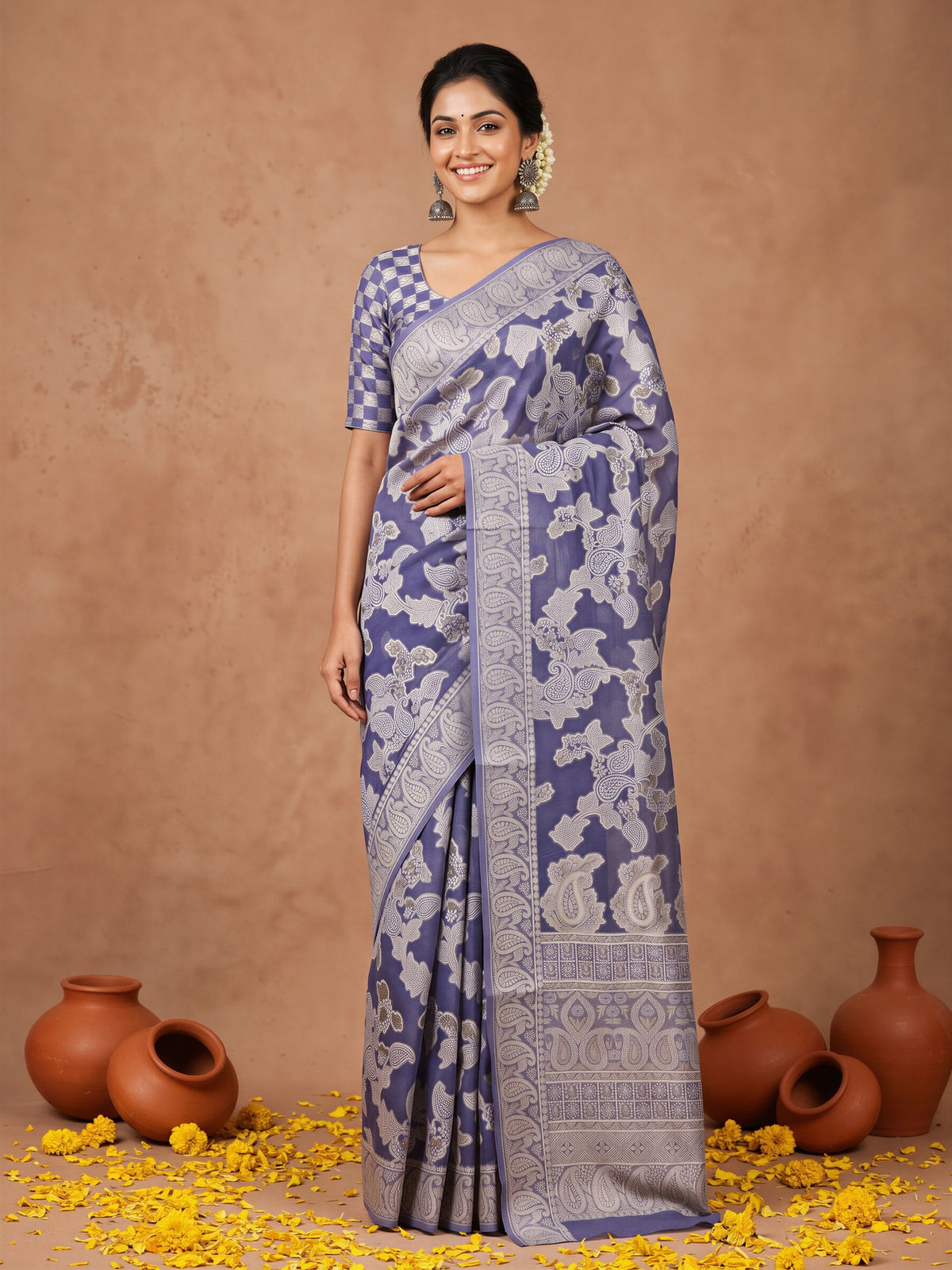 Woman wearing navy blue organza saree with traditional indian motif work and navy blue blouse