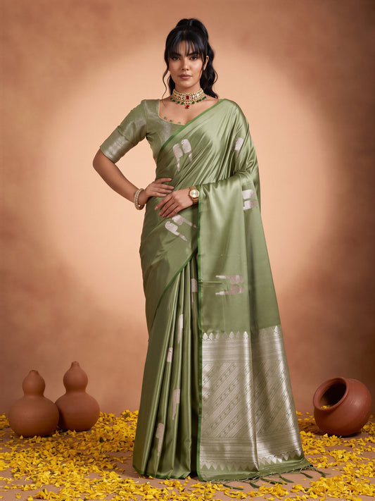 Woman wearing green satin saree with botanical floral and leaf design and green blouse