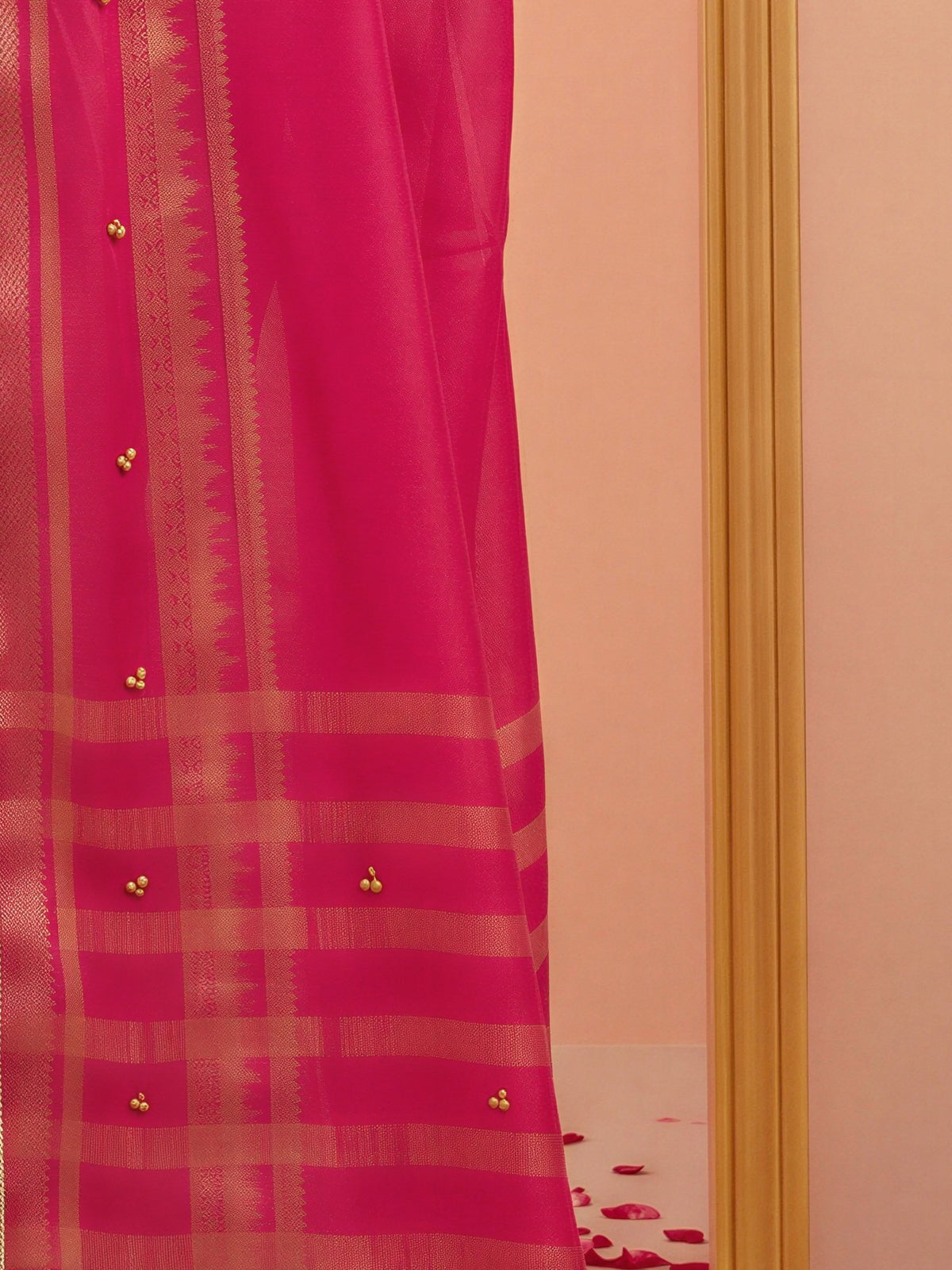 Pallu detail of pink soft silk saree showing woven motif design and zari border