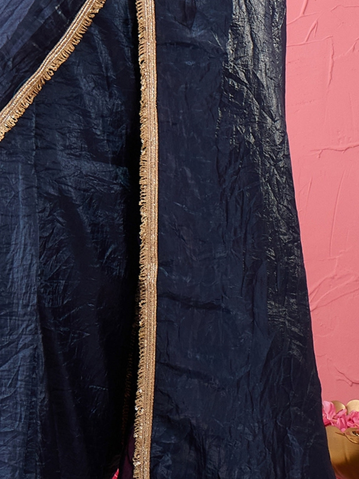 Pallu detail of teal blue tissue saree showing clean solid-tone finish and embellished border