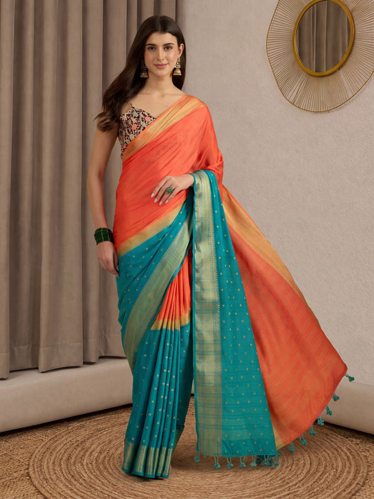 Woman wearing orange mysore silk saree with zari butta (metallic motif) work and assorted blouse