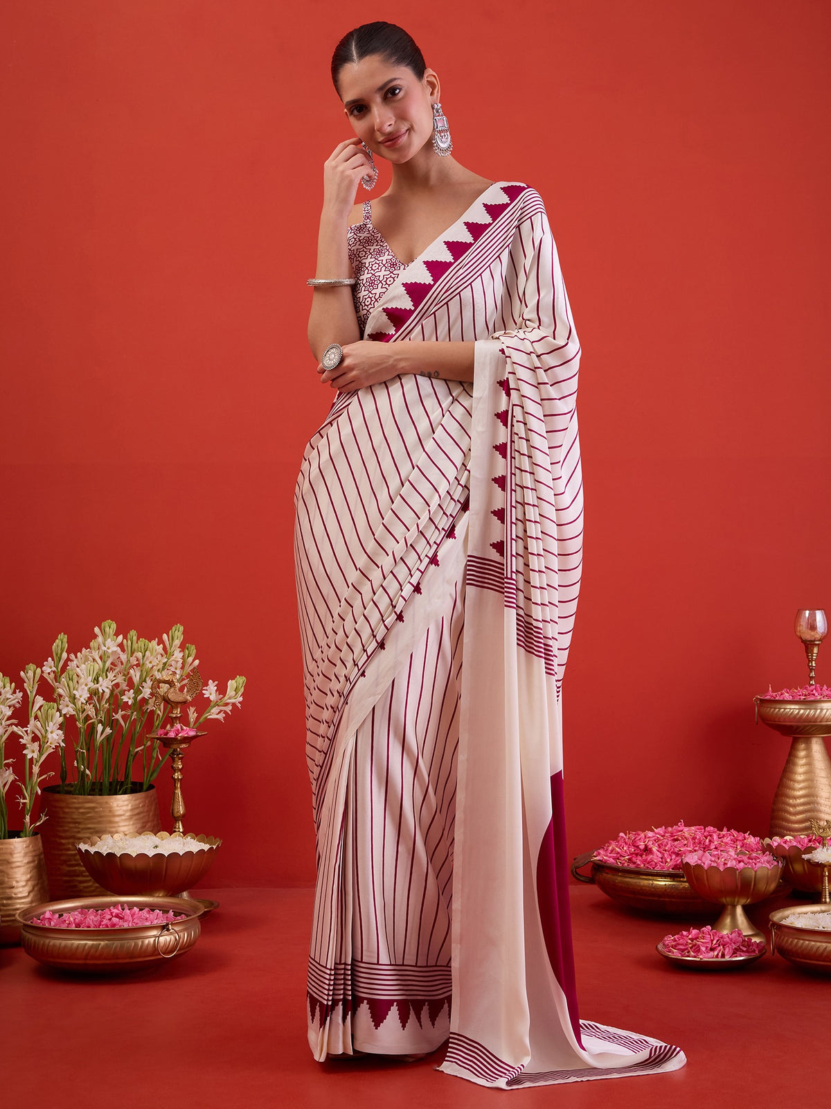 Woman wearing white satin ready to wear saree with striped pattern design and white blouse