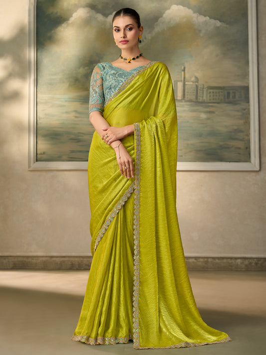 Woman wearing lime green satin silk saree with embroidered motif work and sea green blouse