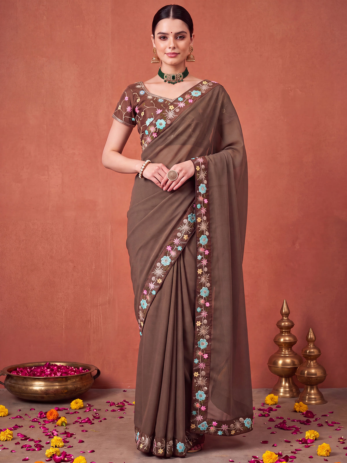 Woman wearing brown poly georgette saree with all-over floral design and brown blouse