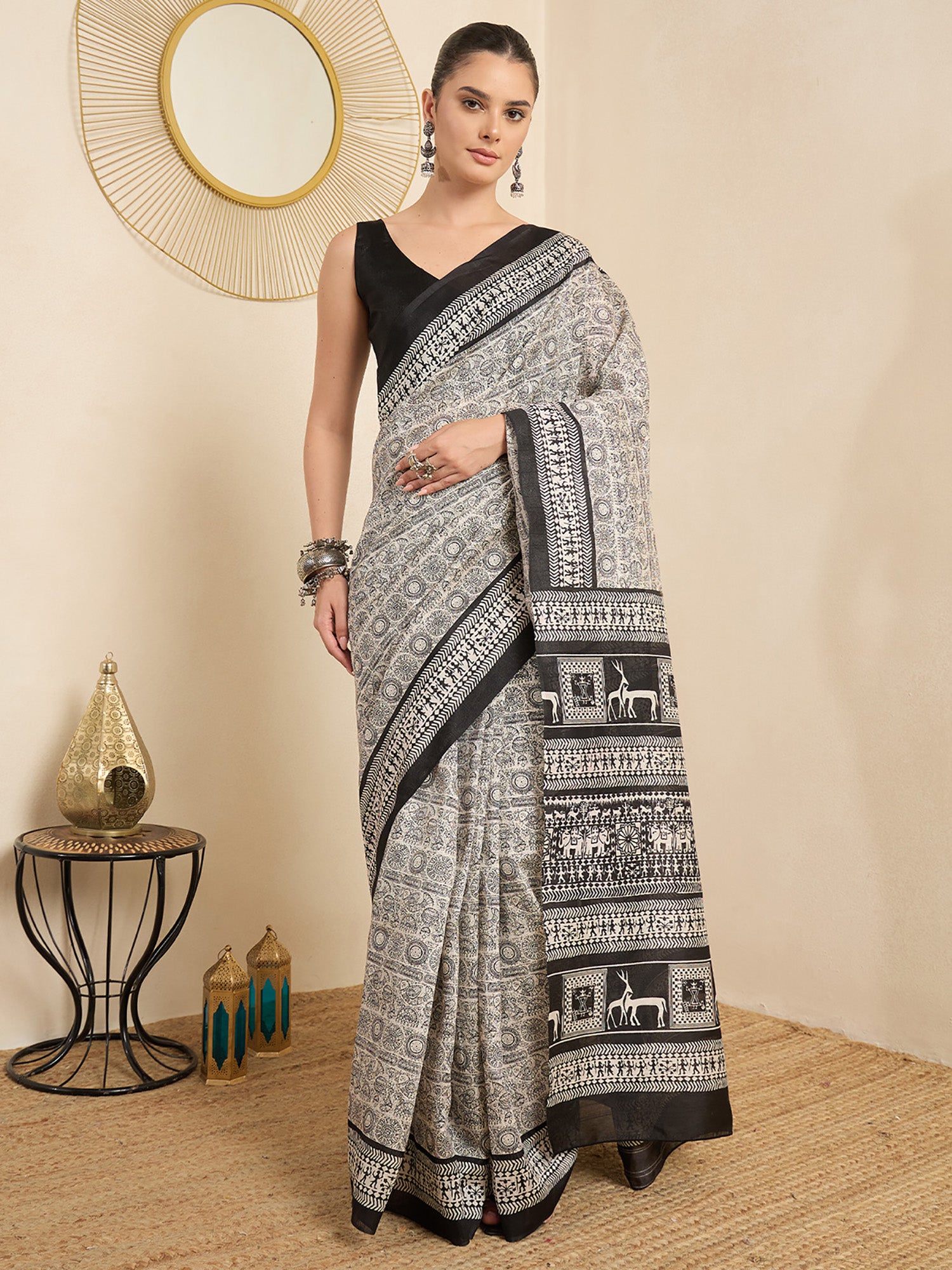 Woman wearing beige bhagalpuri silk saree with tribal folk-art motifs and black blouse