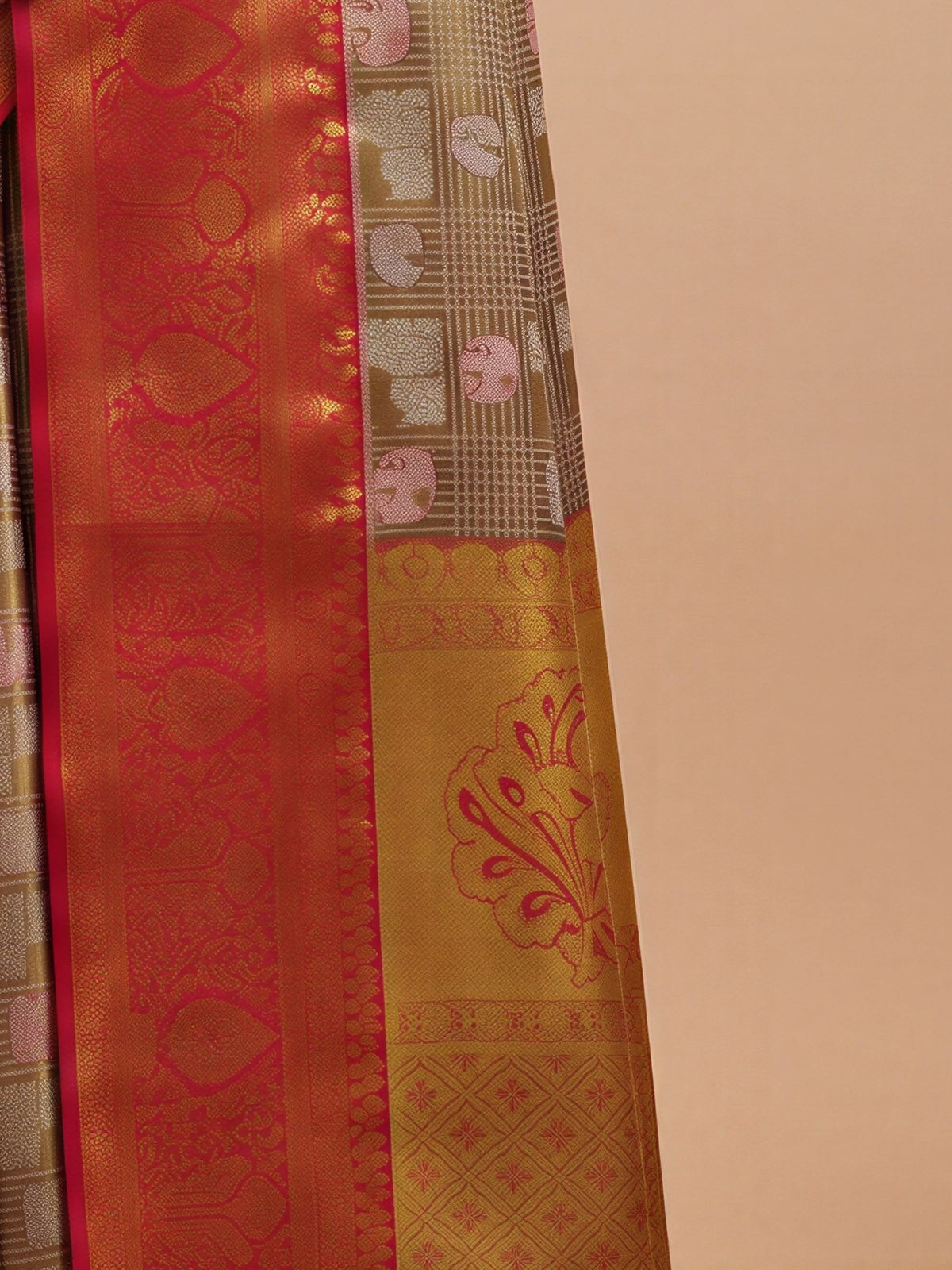 Pallu detail of gold banarasi silk saree showing traditional indian motif work and zari border