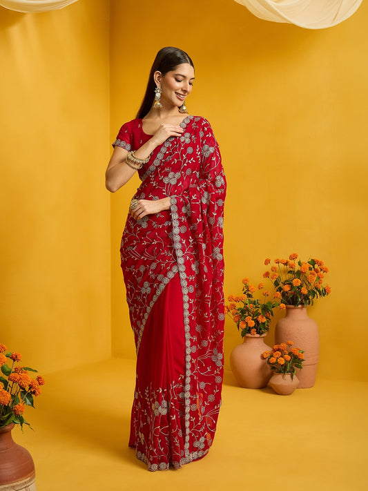 Woman wearing red georgette saree with ornamented surface design and red blouse