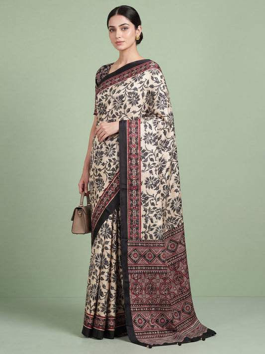Woman wearing cream satin saree with ajrak block-print motif work and black blouse