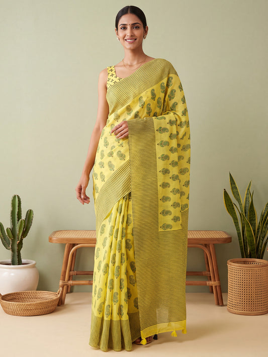 Woman wearing lemon yellow cotton linen saree with traditional indian motif work and lemon yellow blouse