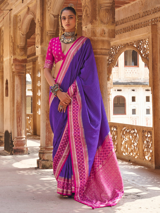 Woman wearing violet silk blend saree with clean solid-tone finish and pink blouse