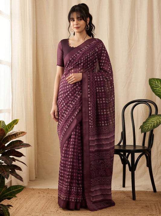 Woman wearing purple cotton linen saree with batik wax-resist design and purple blouse