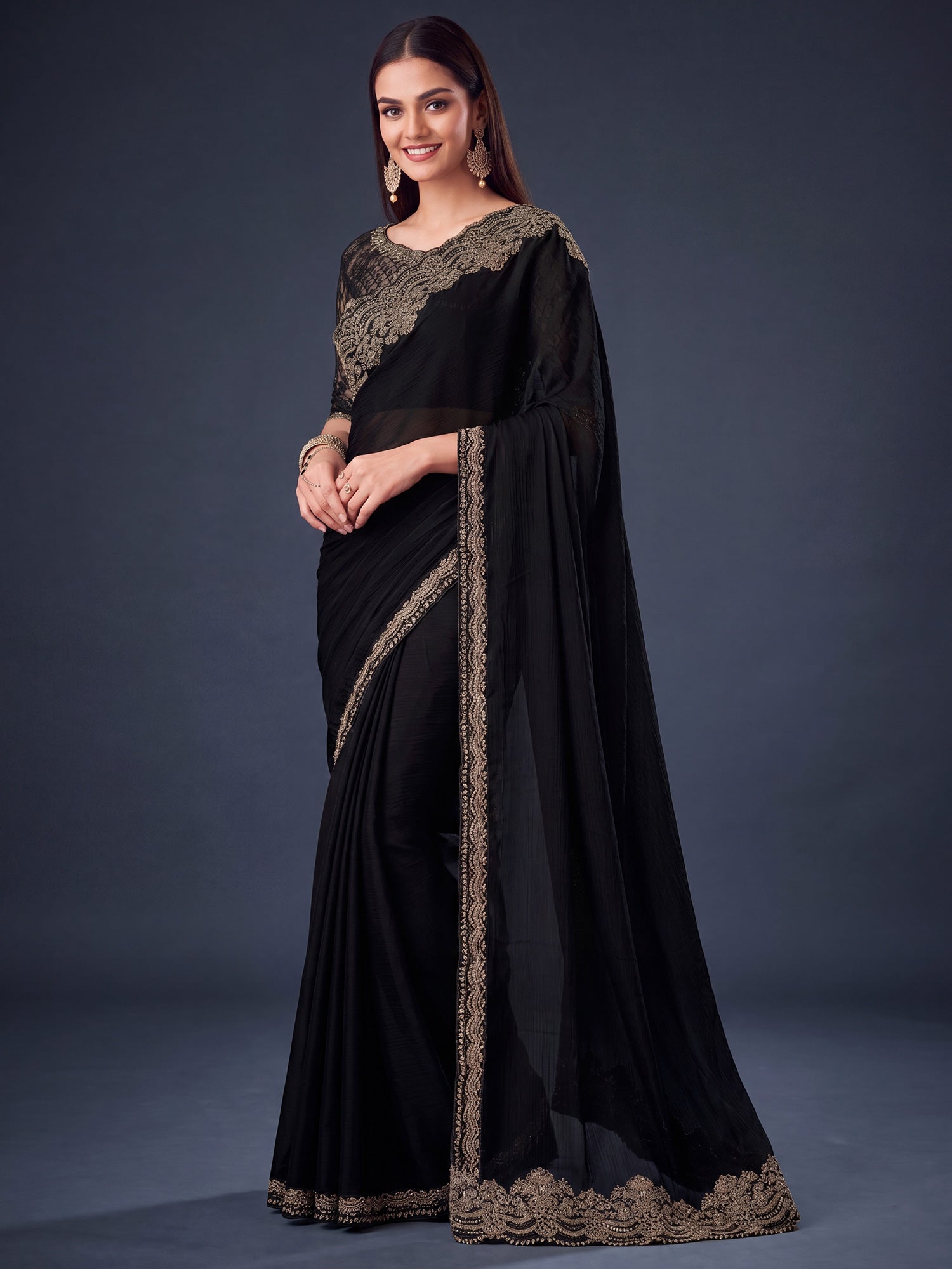 Woman wearing black satin silk saree with embroidered motif work and black blouse