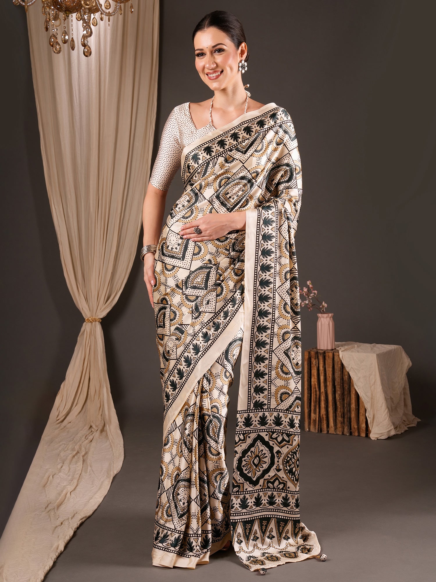 Woman wearing off white satin saree with ajrak block-print motif work and off white blouse