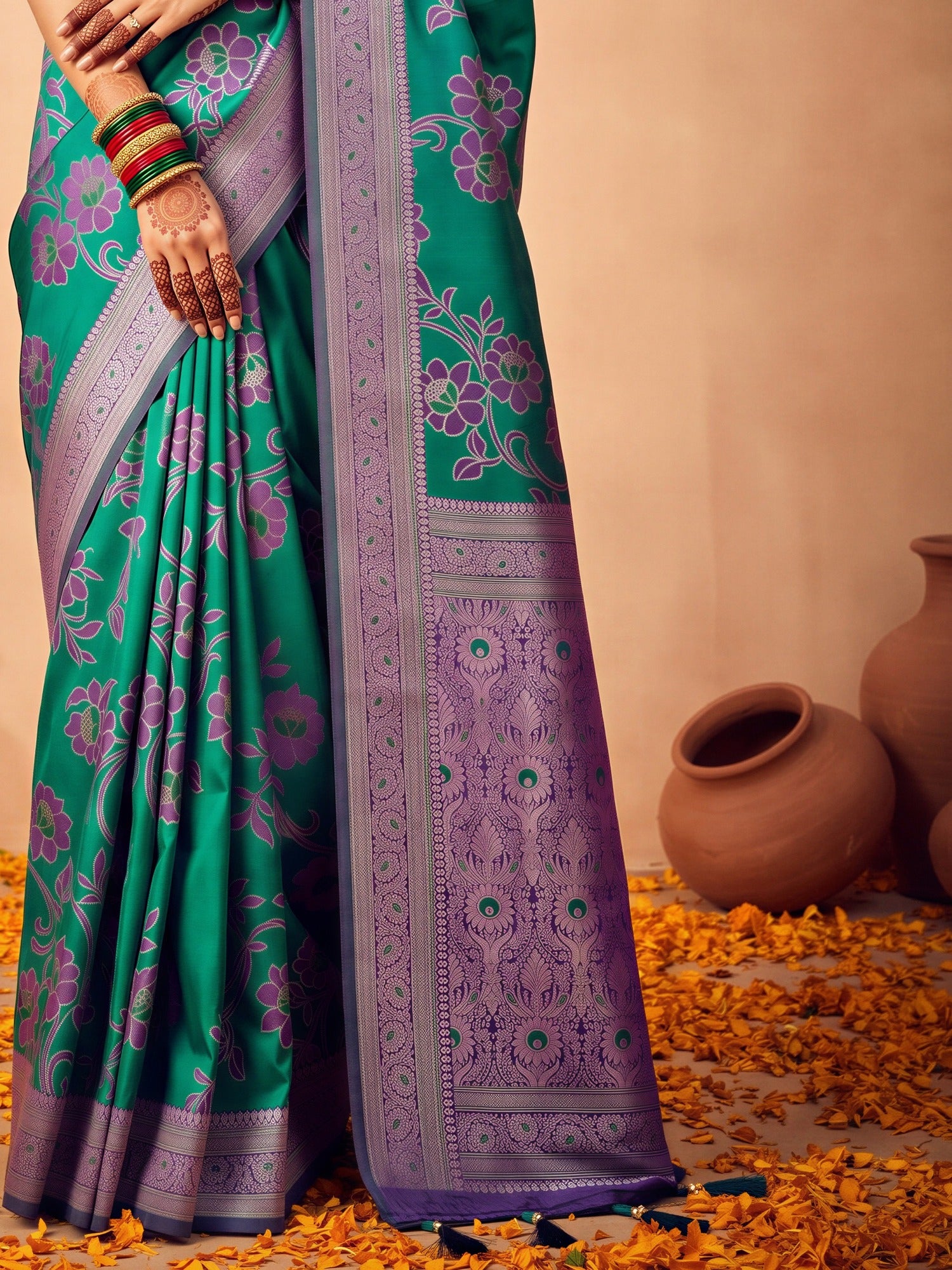 Pallu detail of teal green satin silk saree showing botanical floral and leaf design and zari border
