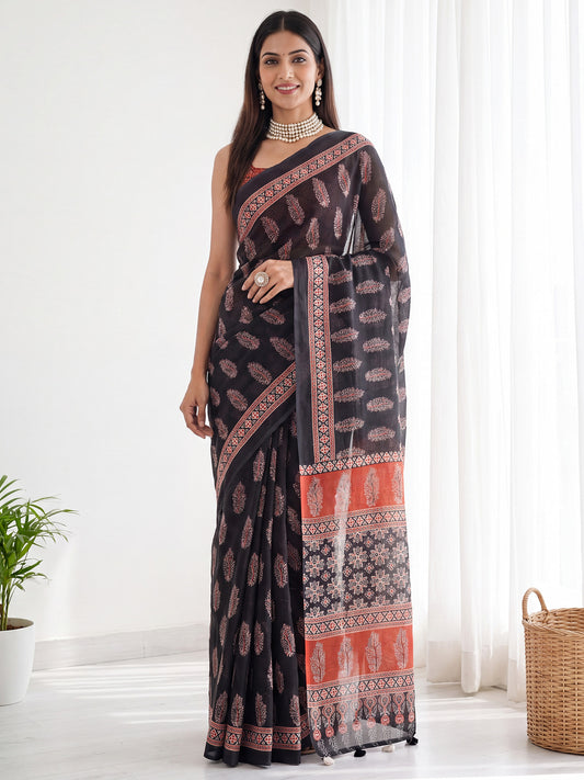 Woman wearing black cotton linen saree with bagh block-print motif work and maroon blouse