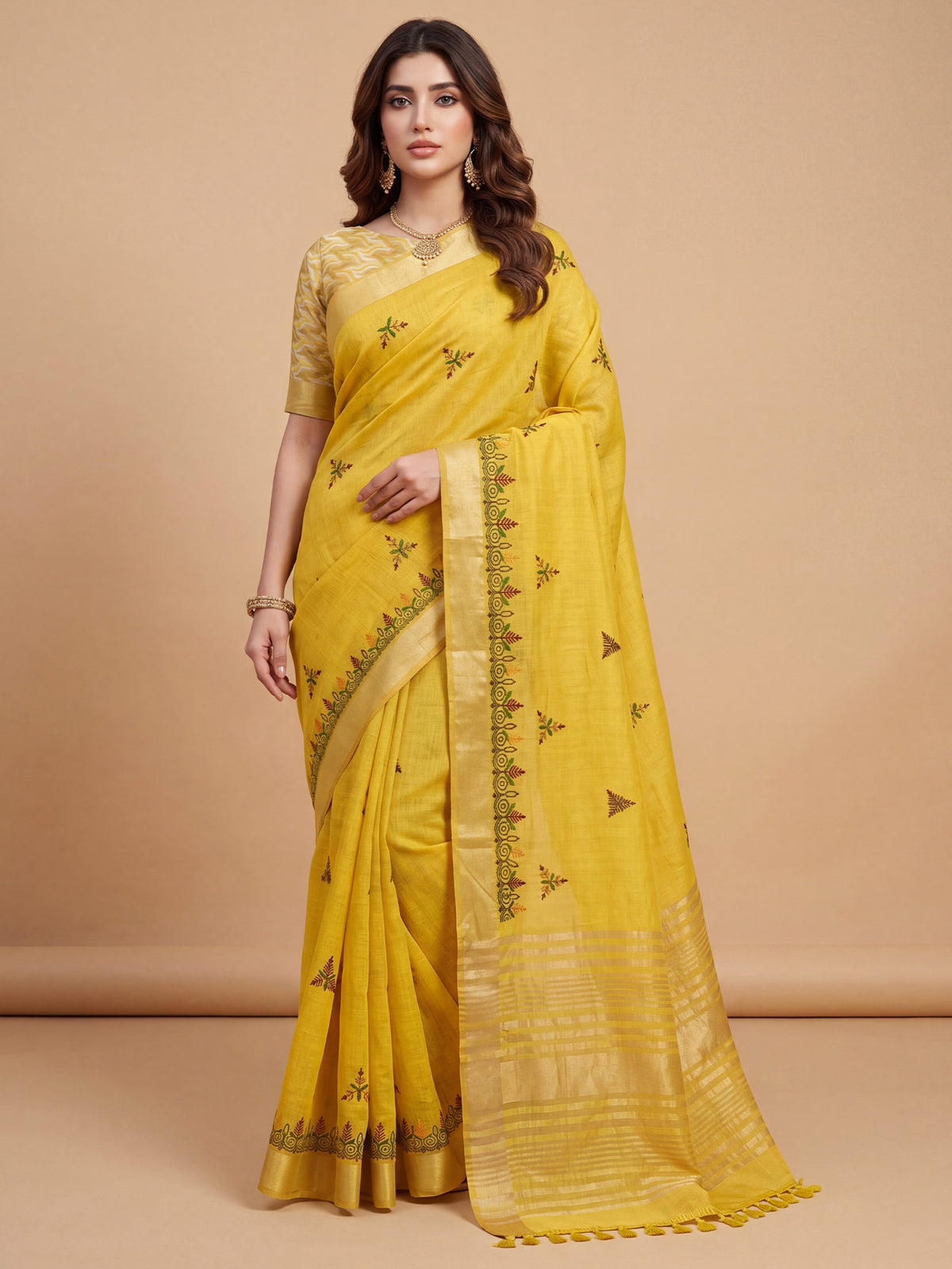 Woman wearing yellow cotton linen saree with embroidered motif work and yellow blouse