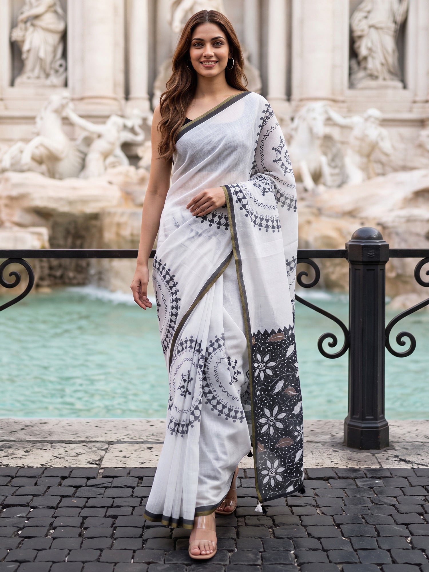Woman wearing white cotton blend saree with warli folk-art figures and black blouse