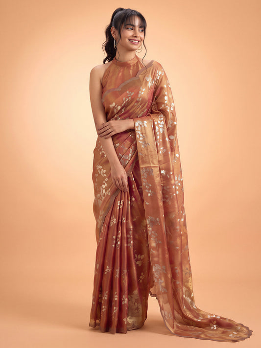Woman wearing rust satin silk saree with metallic foil print work and rust blouse