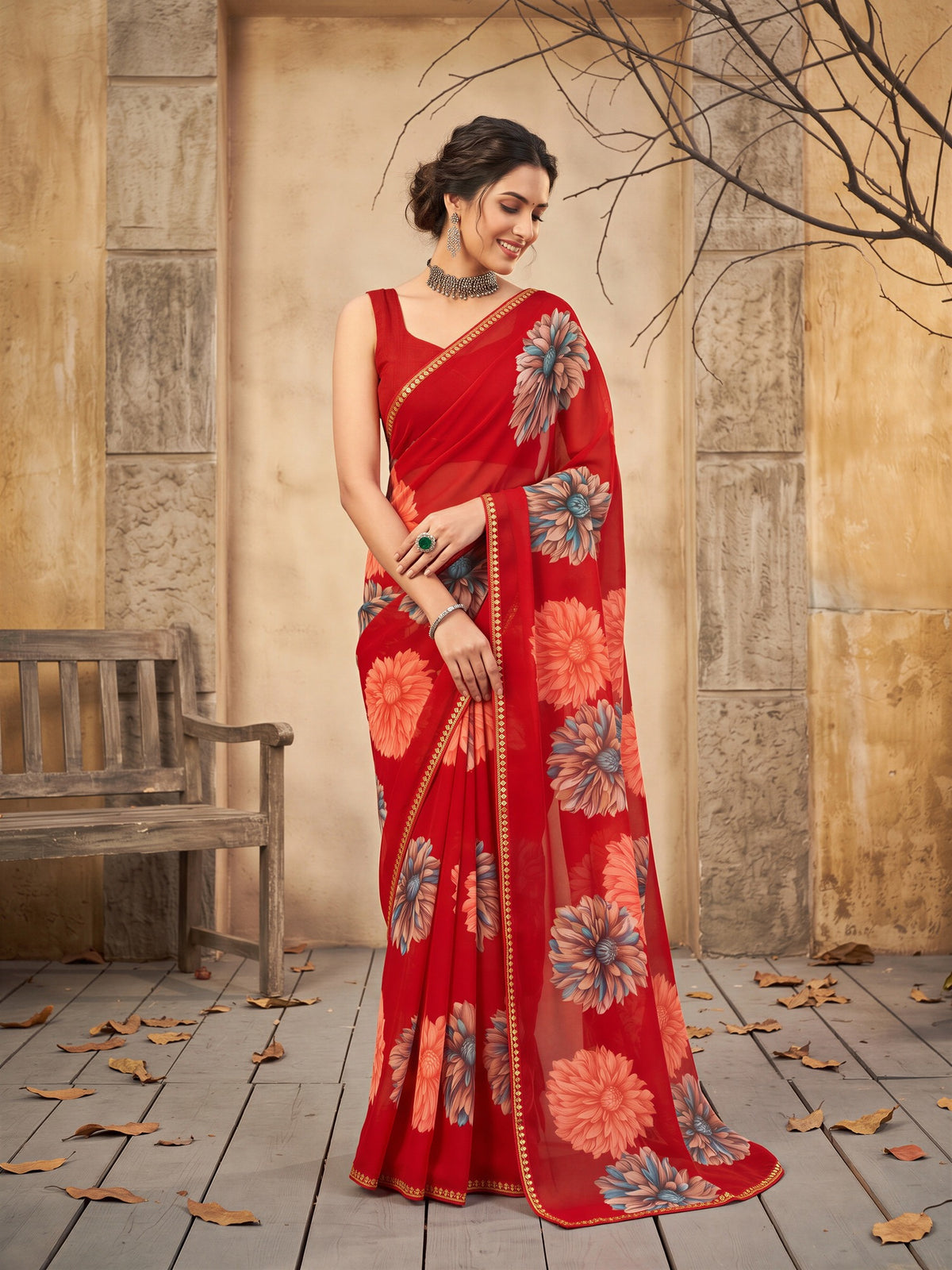Woman wearing red georgette saree with all-over floral design and red blouse