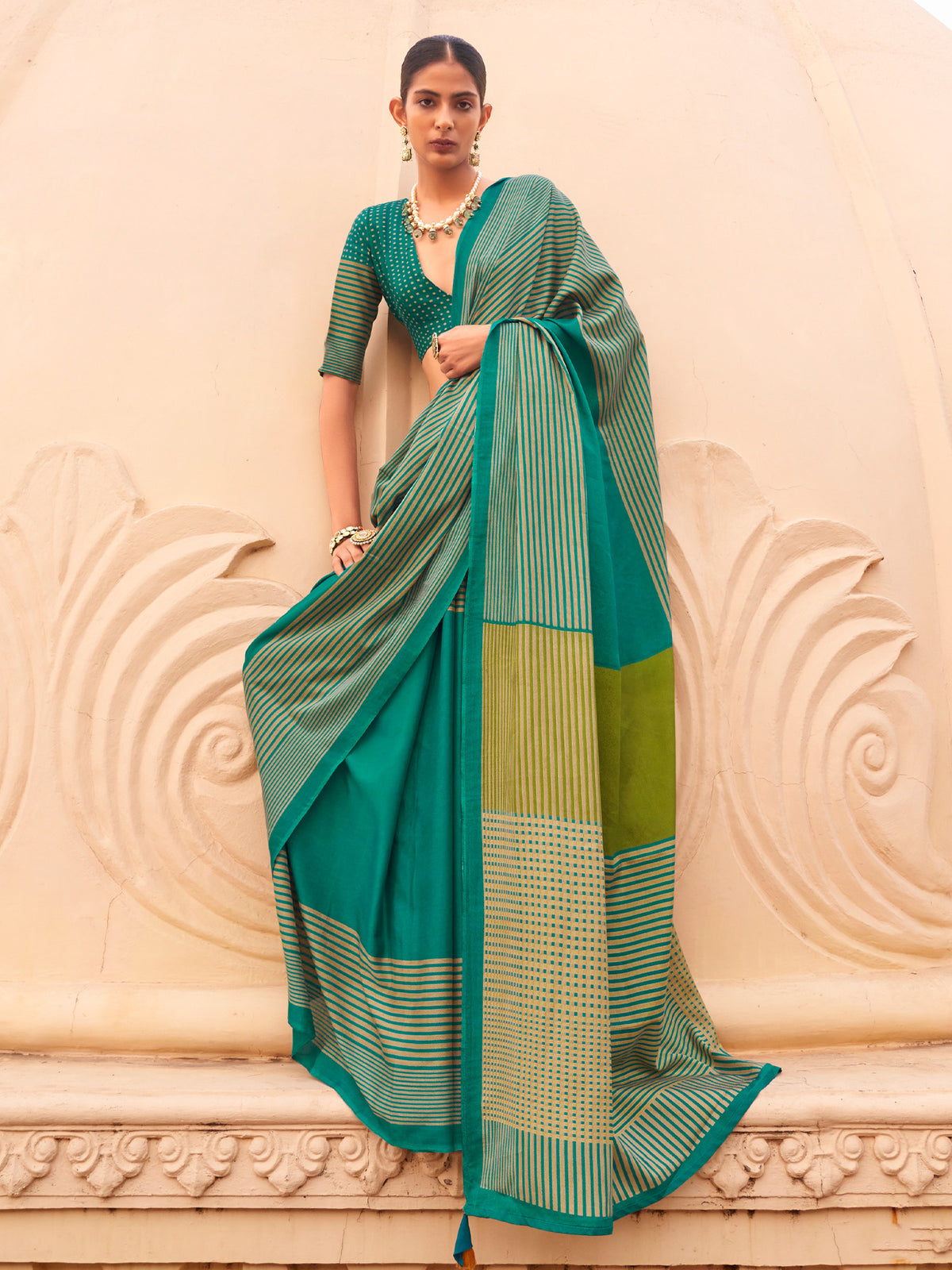 Woman wearing teal green silk blend saree with striped pattern design and teal green blouse