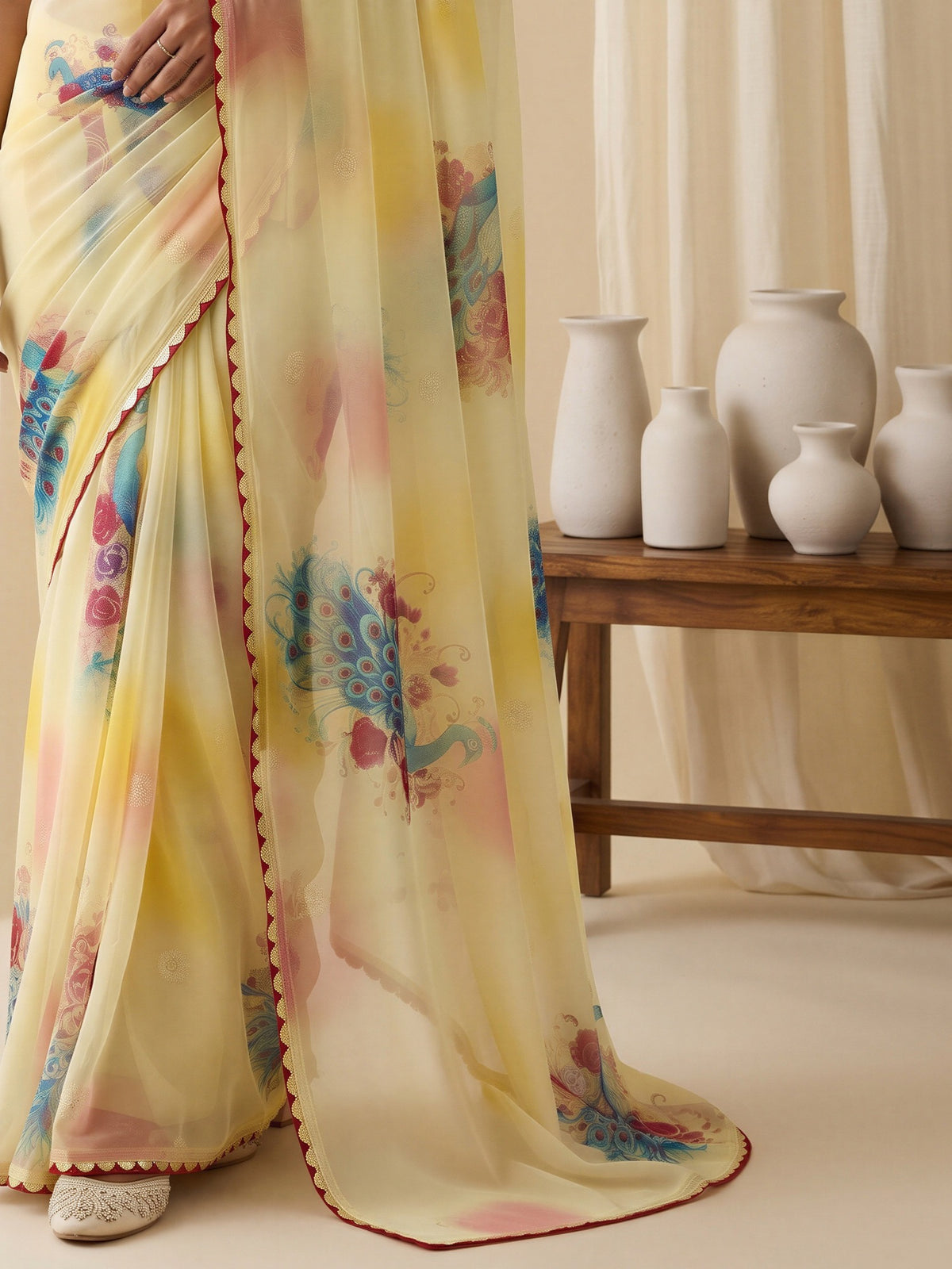Pallu detail of yellow georgette saree showing metallic foil print work and printed border