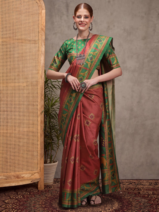 Woman wearing rust silk blend saree with traditional indian motif work and green blouse