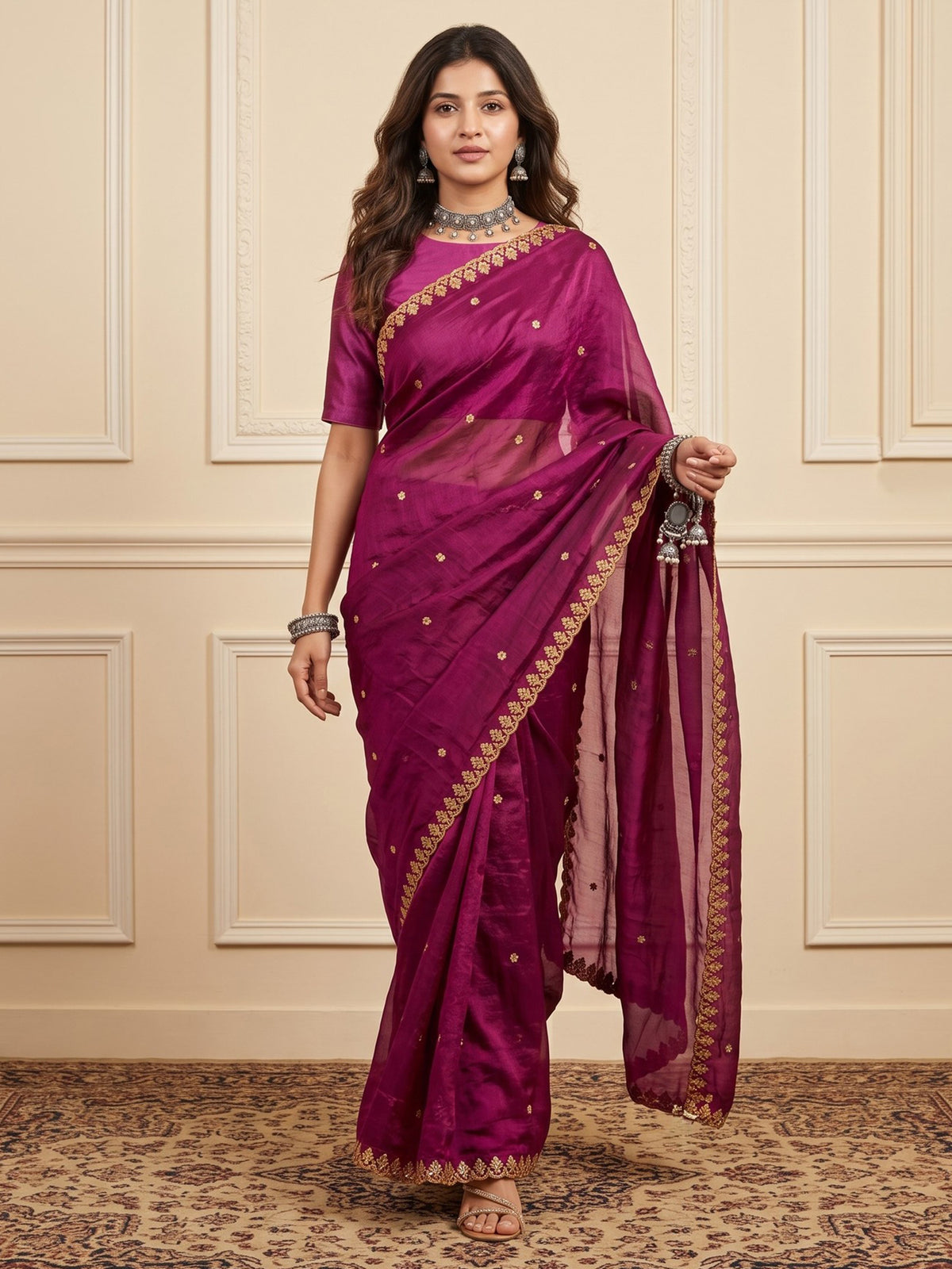 Woman wearing magenta paper silk saree with embroidered motif work and magenta blouse