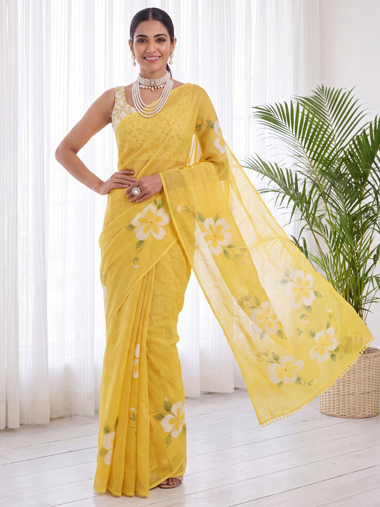 Woman wearing yellow cotton linen saree with all-over floral design and yellow blouse