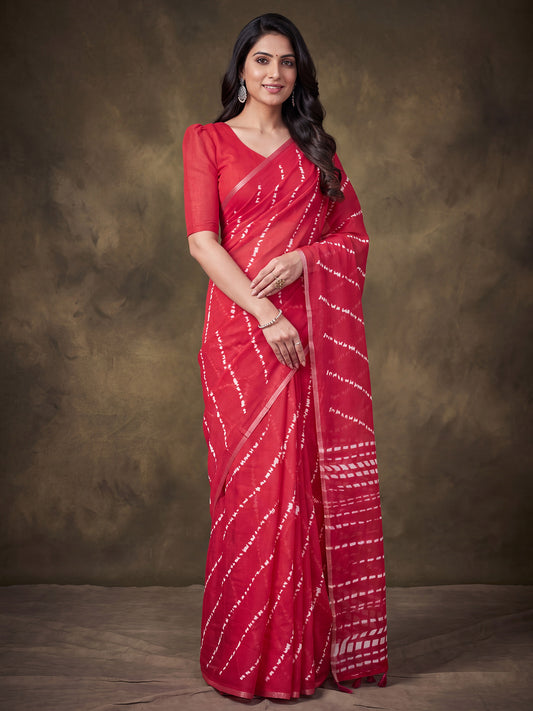 Woman wearing red cotton linen saree with shibori resist-dye pattern and red blouse