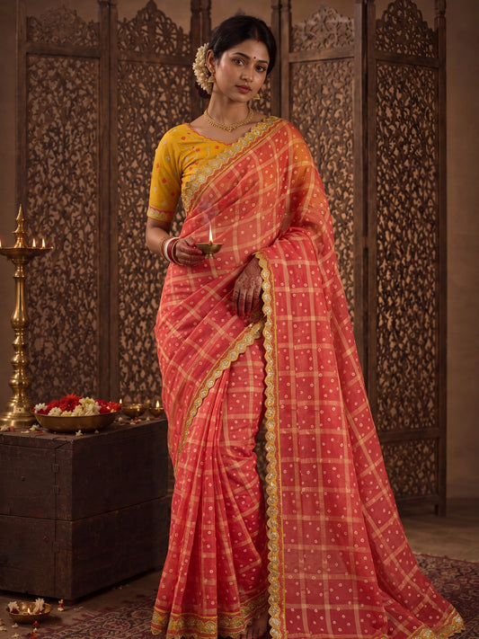 Woman wearing red viscose saree with bandhani tie-dye dot work and yellow blouse