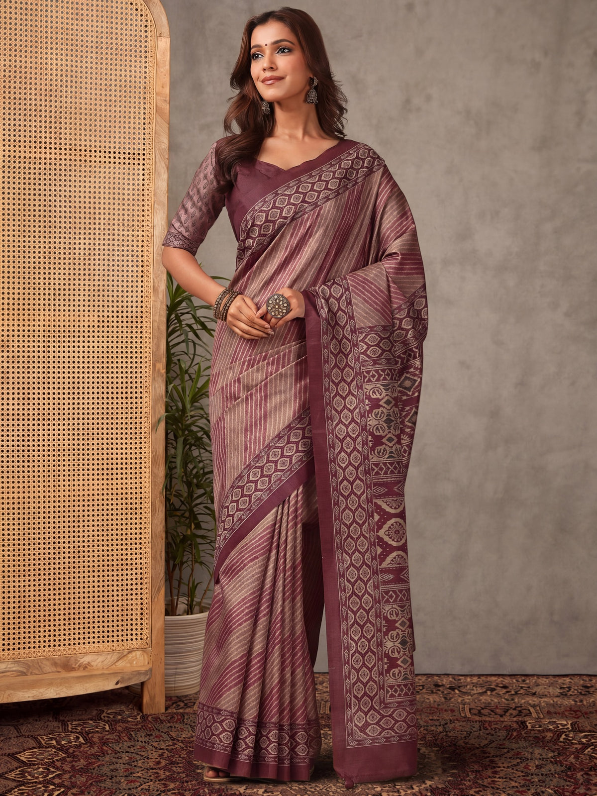 Woman wearing mauve silk blend saree with striped pattern design and mauve blouse