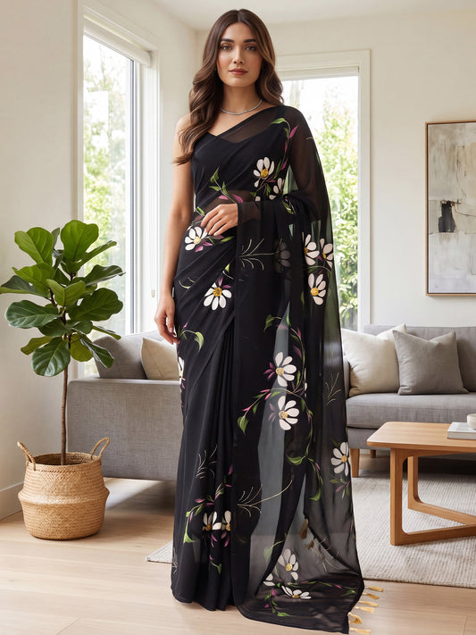 Woman wearing black georgette saree with all-over floral design and black blouse