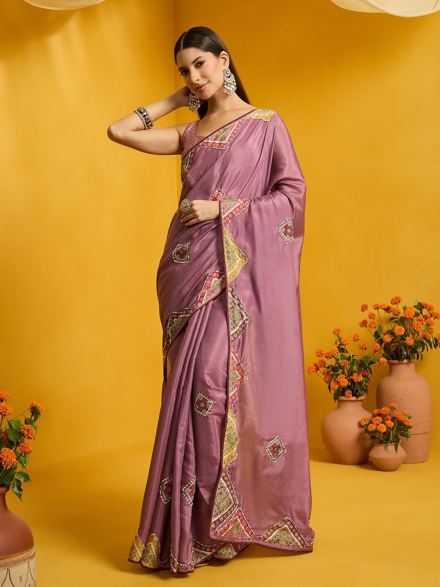 Woman wearing lavender silk cotton saree with traditional indian motif work and lavender blouse