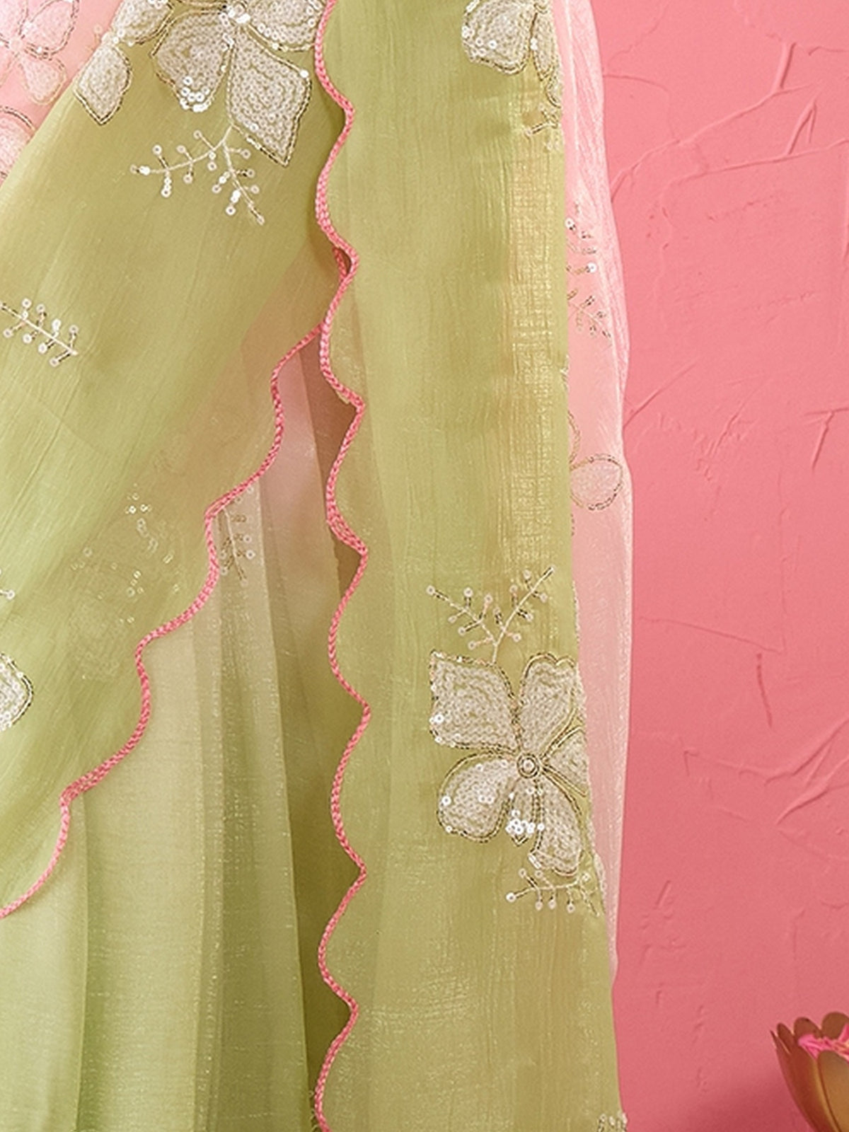 Pallu detail of pink chiffon saree showing ornamented surface design and embroidered border
