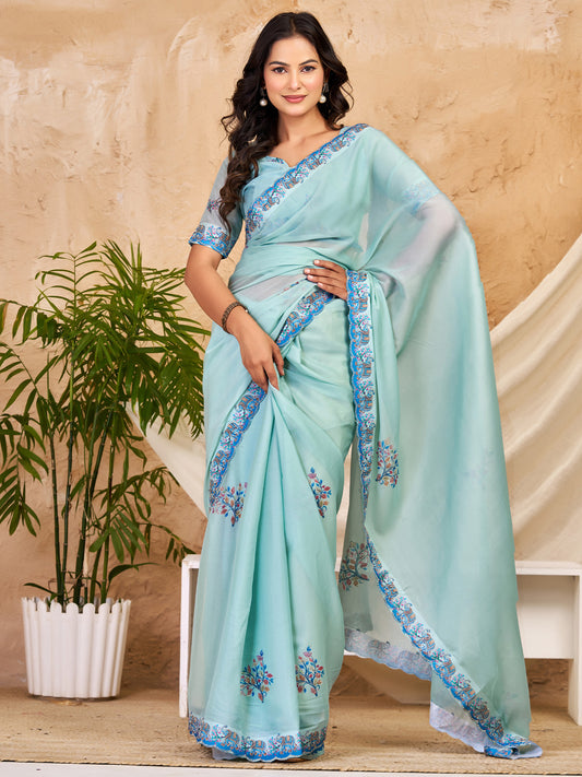 Woman wearing light blue georgette saree with traditional indian motif work and light blue blouse