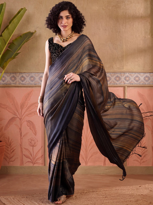Woman wearing black poly georgette saree with striped pattern design and brown blouse