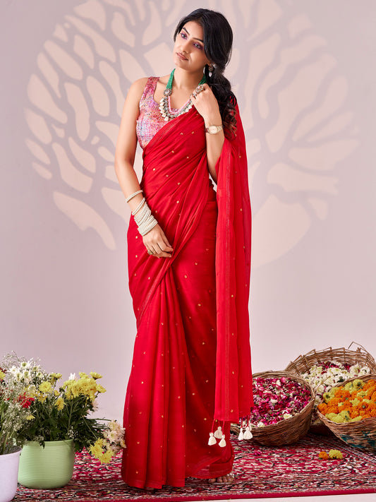 Woman wearing red chiffon saree with ornamented surface design and multicolored blouse
