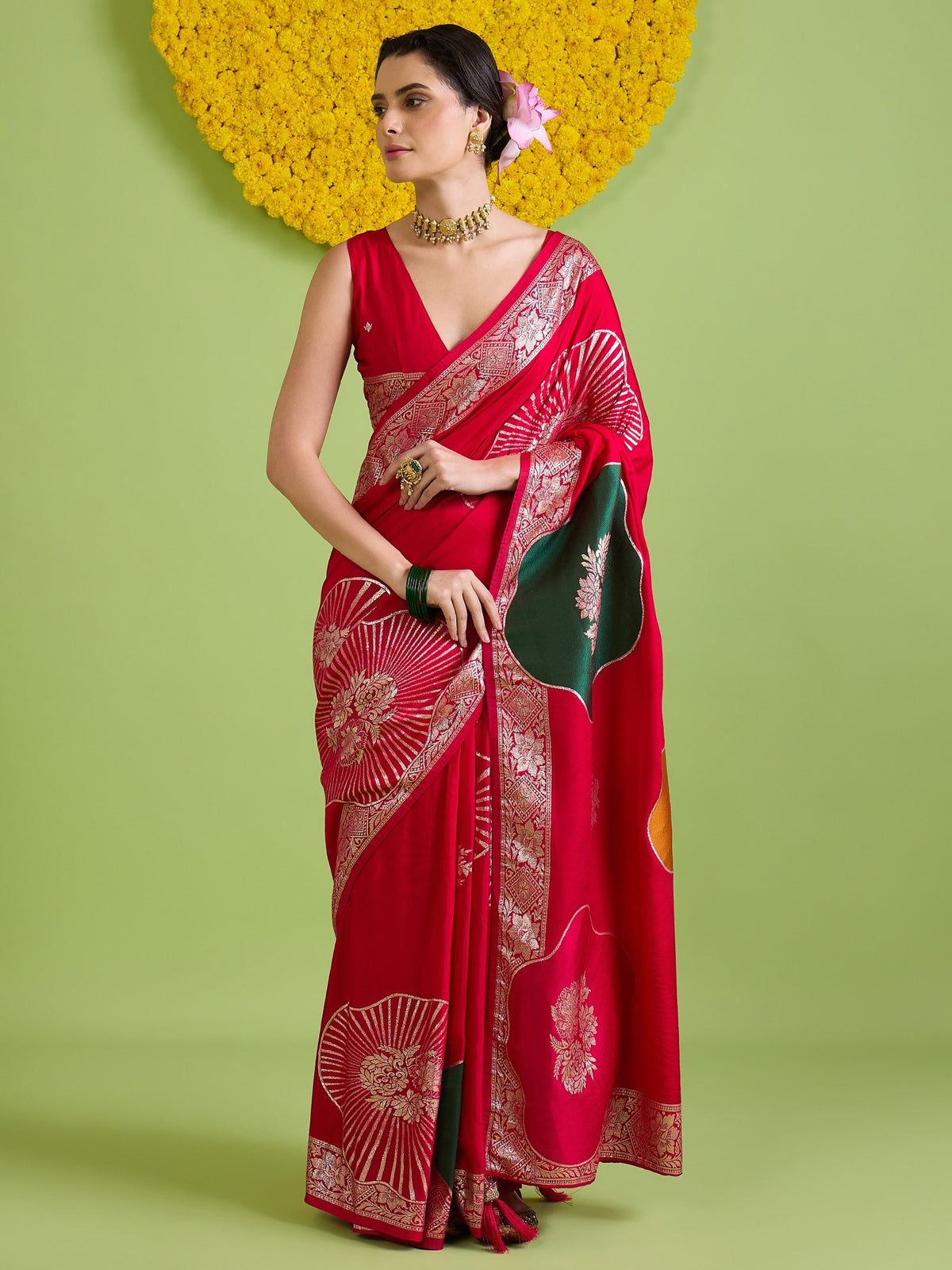 Woman wearing red silk blend saree with zari butta (metallic motif) work and red blouse